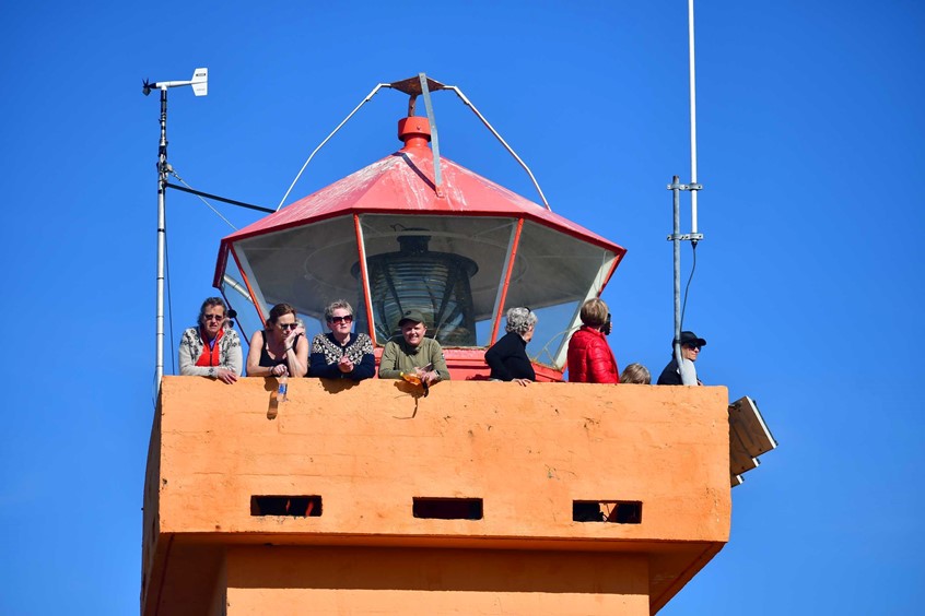 lighthouse with people on top of it