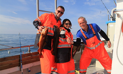 Captain Hallgrímur with happy sea-anglers and their catch.