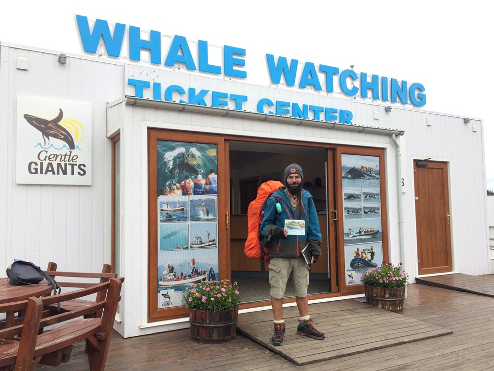 Mert Gültekin outside Gentle Giants' Ticket Center with the painting that he gave to us after his whale watching tour.